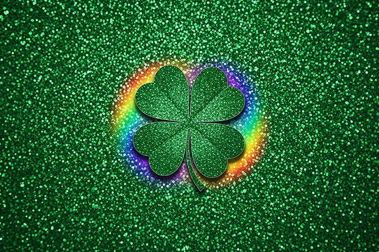 A green four-leaf clover with rainbow glow