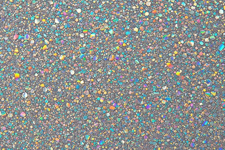 Multicolored glitter on a gray surface