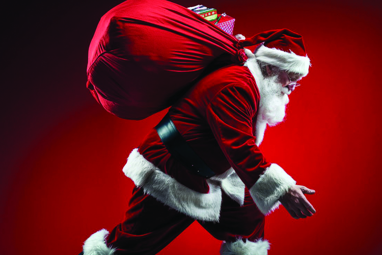 Santa Claus carrying a red sack filled with gifts