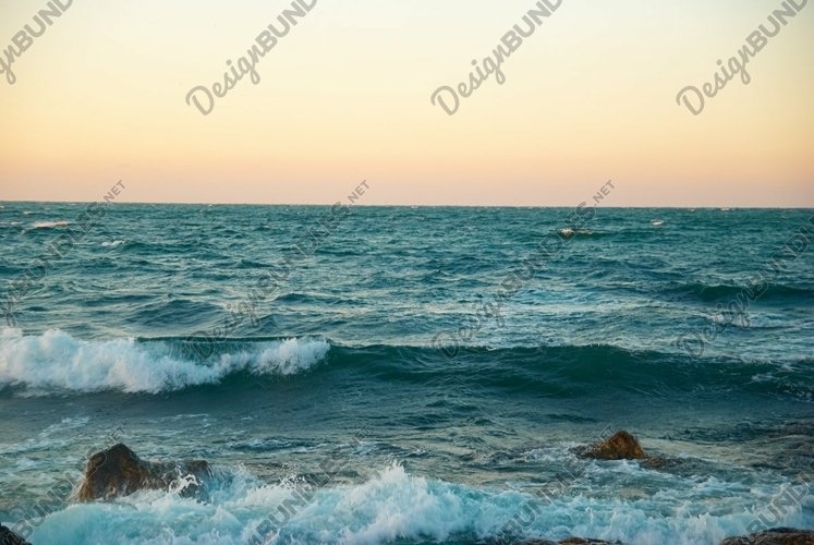 Beautiful sunset above the stormy winter sea