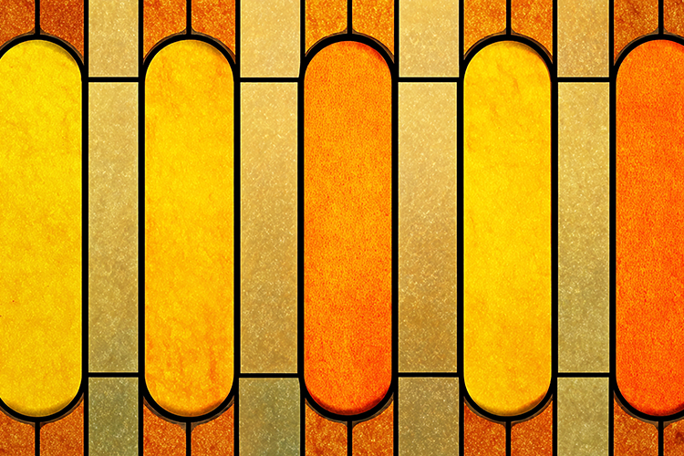 A colorful stained glass window with yellow and orange hues