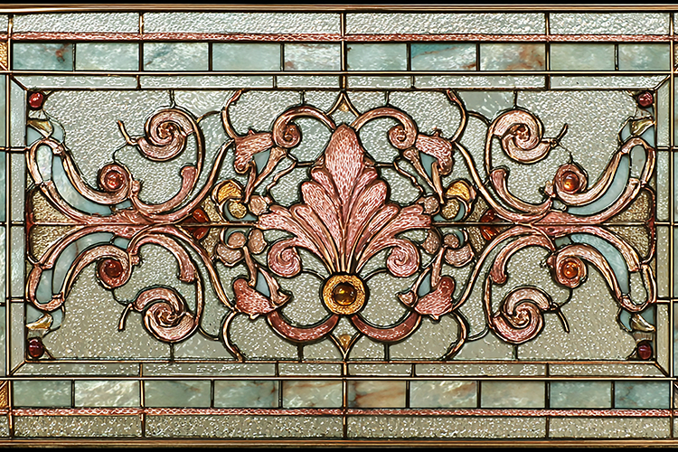 A beautifully designed stained glass with intricate floral