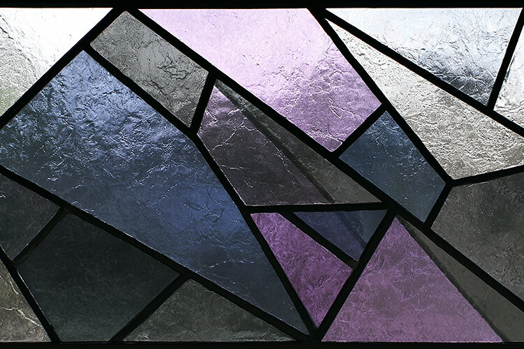 A stained glass window with geometric shapes (6560898)