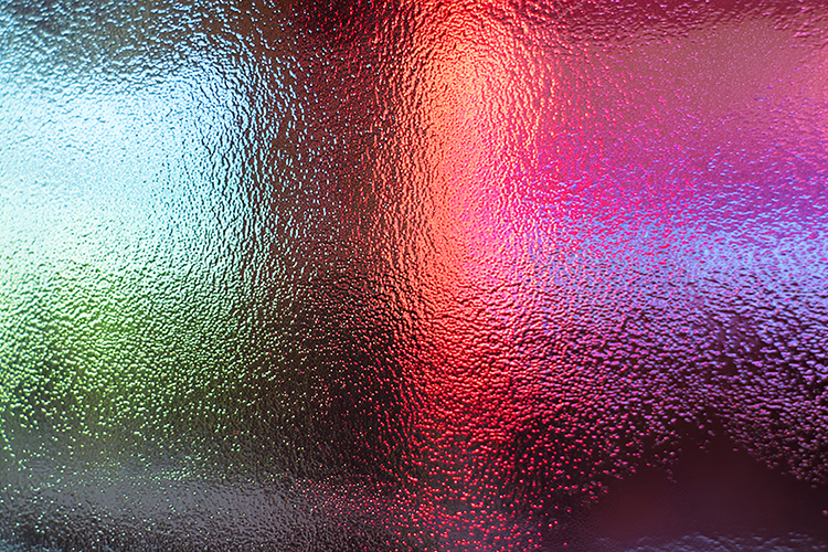A colorful abstract background with textured glass