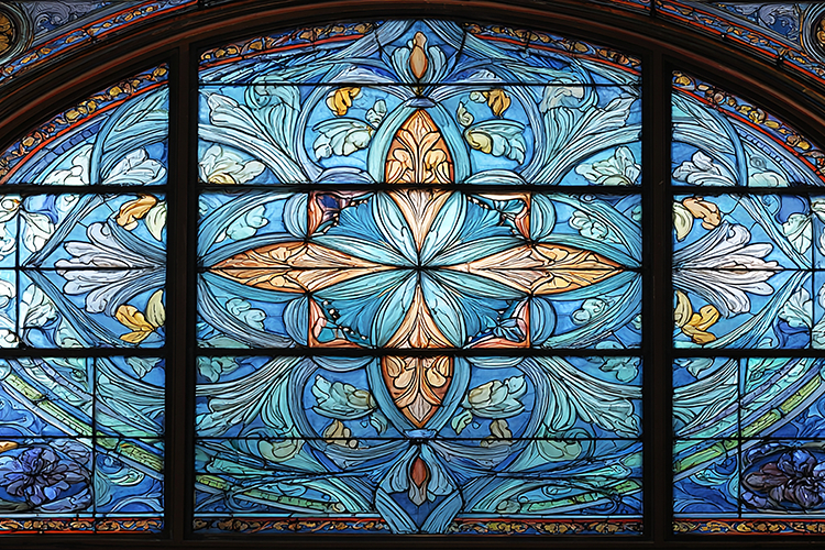A stunning stained glass window with intricate blue and gold