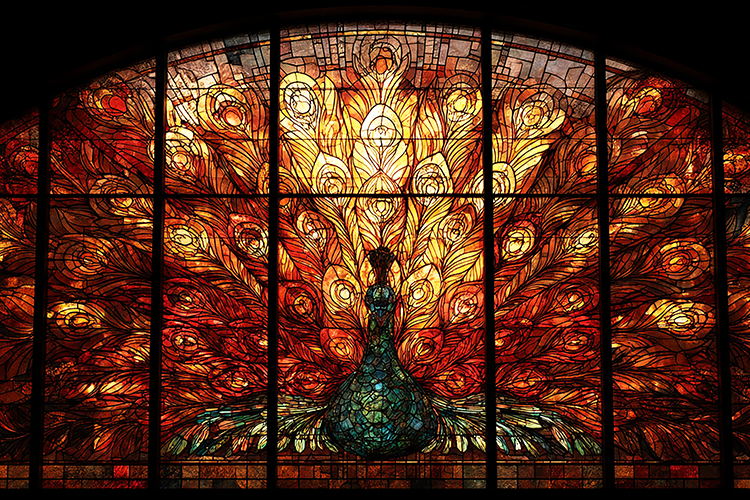 A stunning stained glass window featuring a vibrant peacock