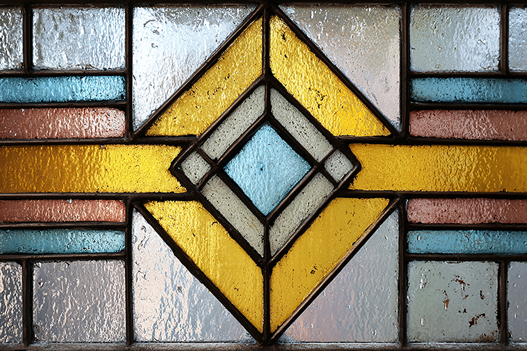 A colorful stained glass window with a geometric design