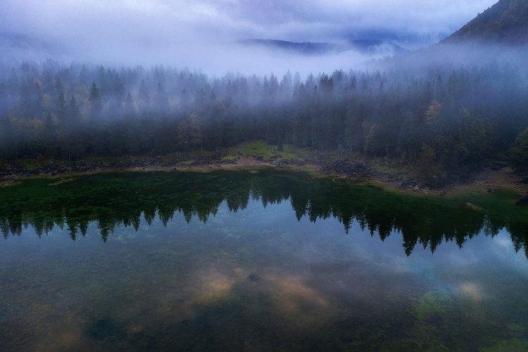 Misty and foggy forest at Fusine Lake example image 1