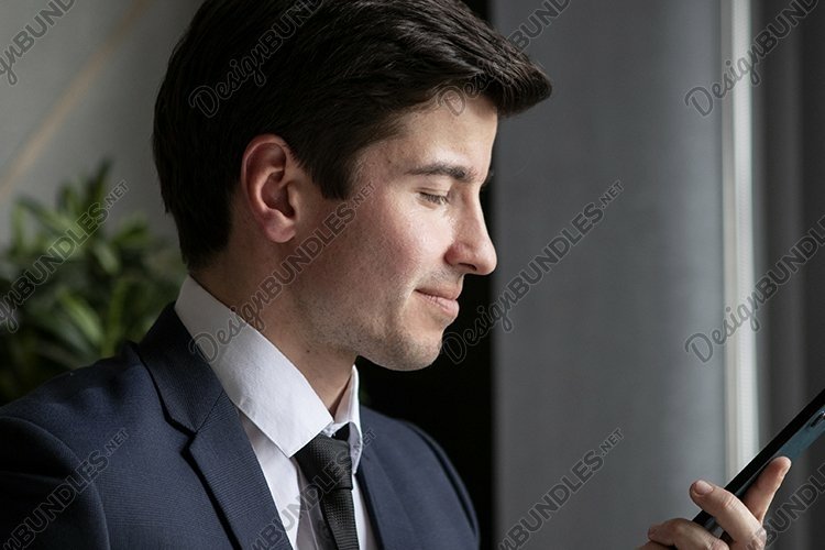 portrait of a businessman in a dark blue suit in the office