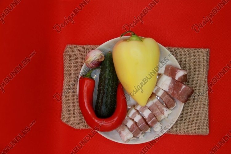 pieces of lard with vegetables on a plate example image 1