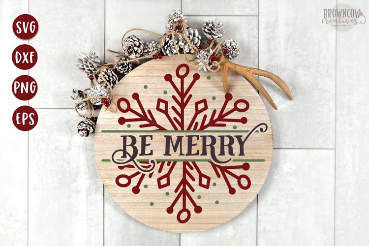 Be Merry text with a hand-drawn split snowflake shown on a round wooden sign