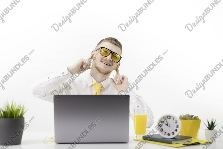 Glad caucasian male office worker makes movements to music.