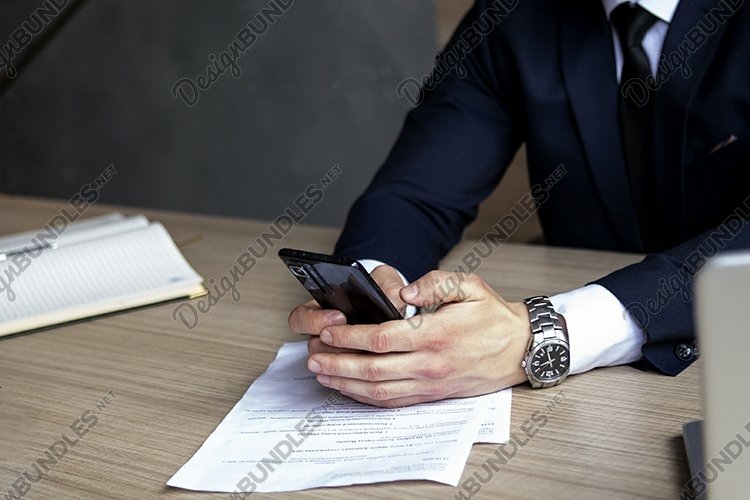 portrait of a businessman in a dark blue suit in the office