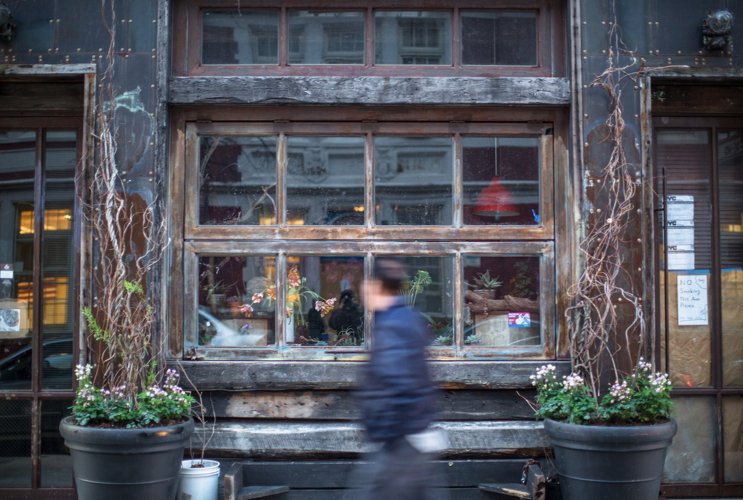 Blurred man passing the store
