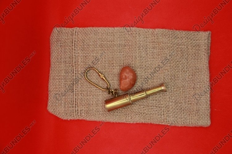 key chain and a red stone on the Mat example image 1