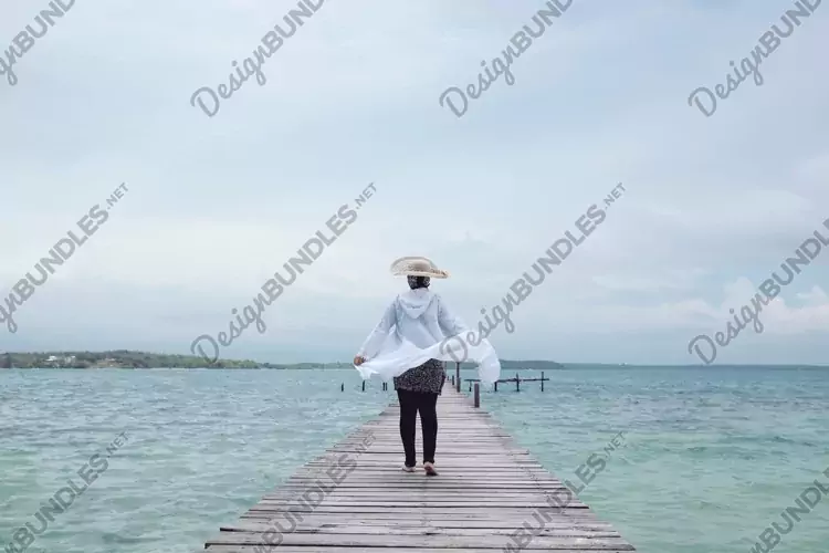 Woman walking on wooden dock