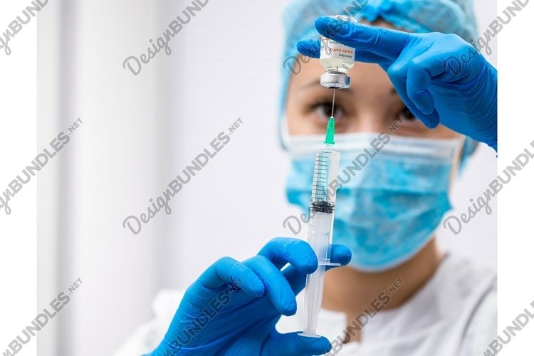 Doctor prepares a syringe with an injection, close-up example image 1