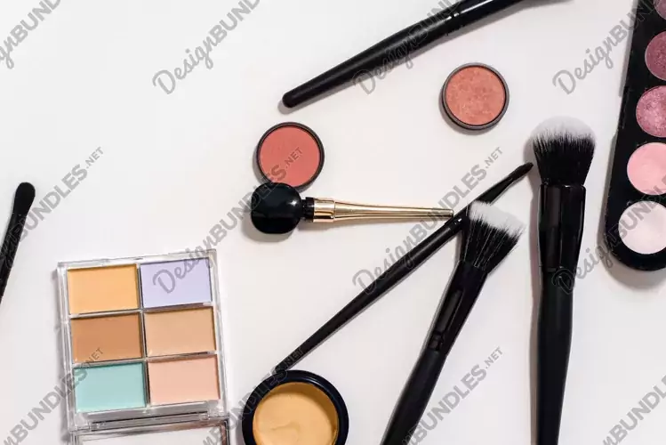 Makeup products on white background with copy space
