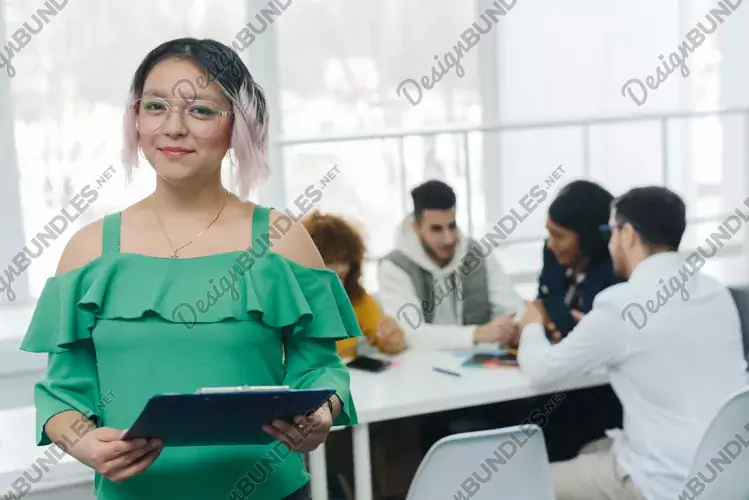 Beautiful young woman looking at camera at office