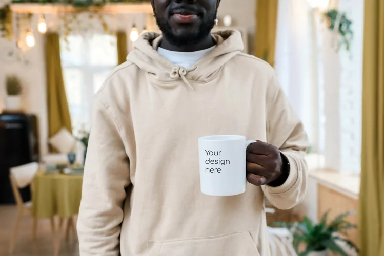 Mockup on a white mug. Close shot in the hands of a man