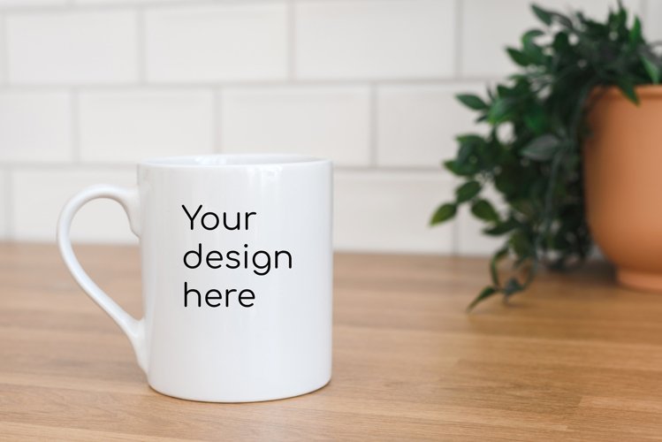 A white mug with a mockup in the kitchen. Jpg and psd files example image 1