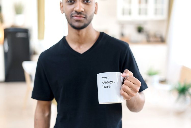 Mockup for your design on a white mug in the hands of a man example image 1