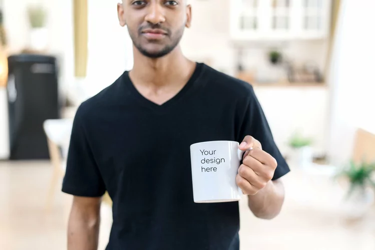 Mockup for your design on a white mug in the hands of a man