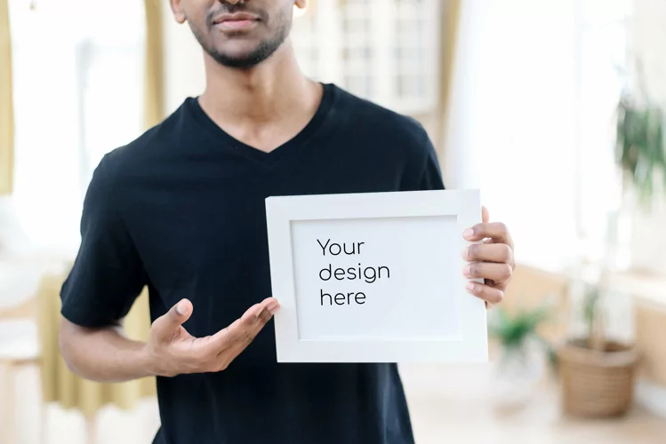 Close up black man holding white frame with copy space