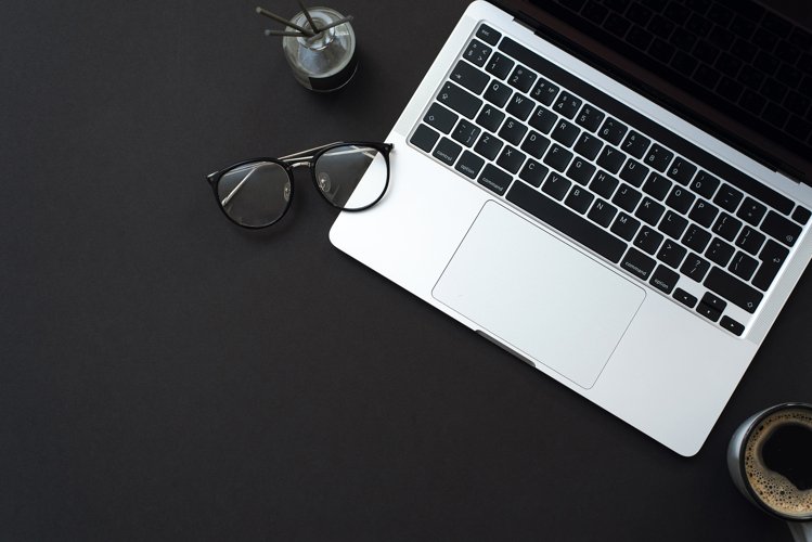 Black background with coffee, laptop and office supplies example image 1