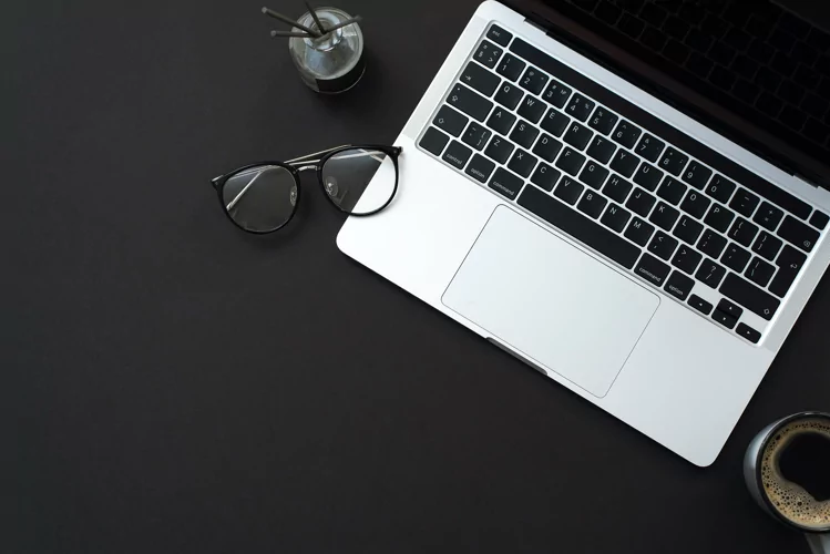 Black background with coffee, laptop and office supplies