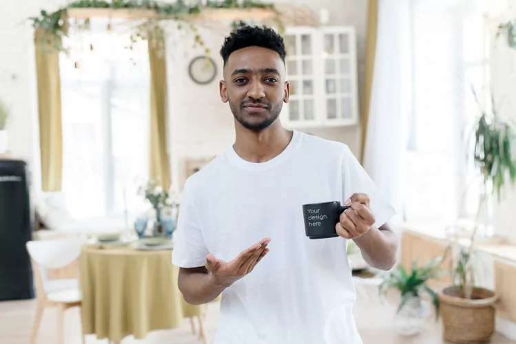 Arab man pointing at black mug with mockup in home interior