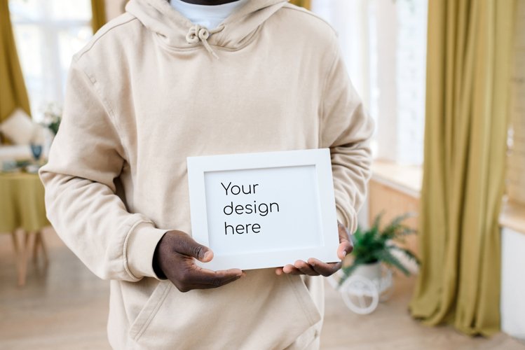 Horizontal white frame in the hands of a black man example image 1