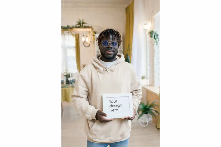 Smiling male model with white frame mockup for design