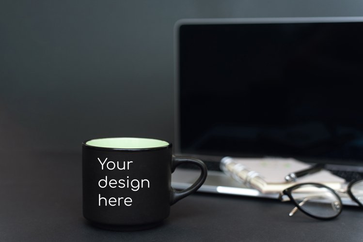 Mockup on a black mug against a black office background example image 1