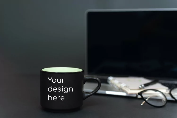 Mockup on a black mug against a black office background