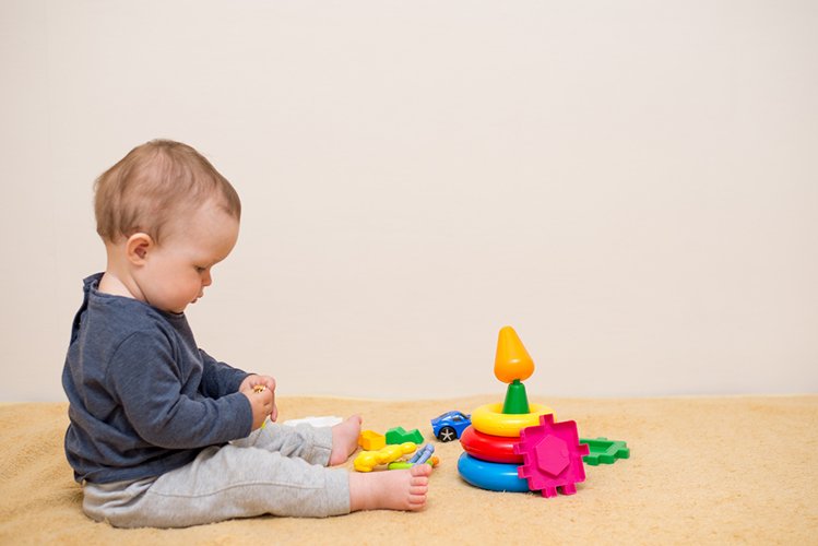 Adorable baby playing with educational toys