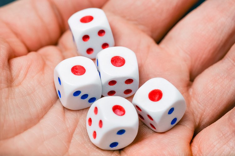 Close up view on dice on the palm. a dice game.