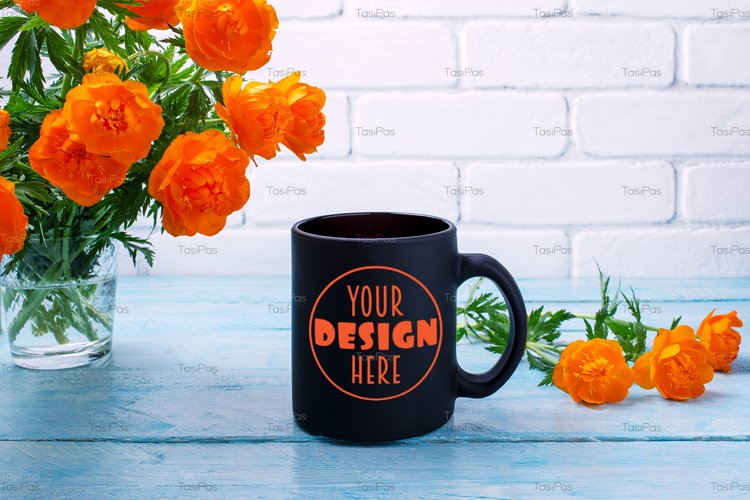 Black coffee mug mockup with globeflowers in the glass