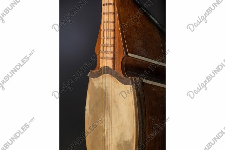 Part ancient Asian stringed musical instrument on black