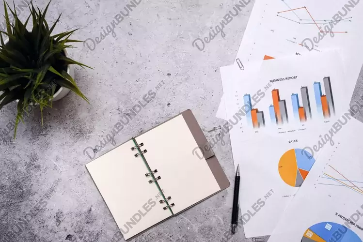 Notepad with a blank white sheet is on the graph. Business