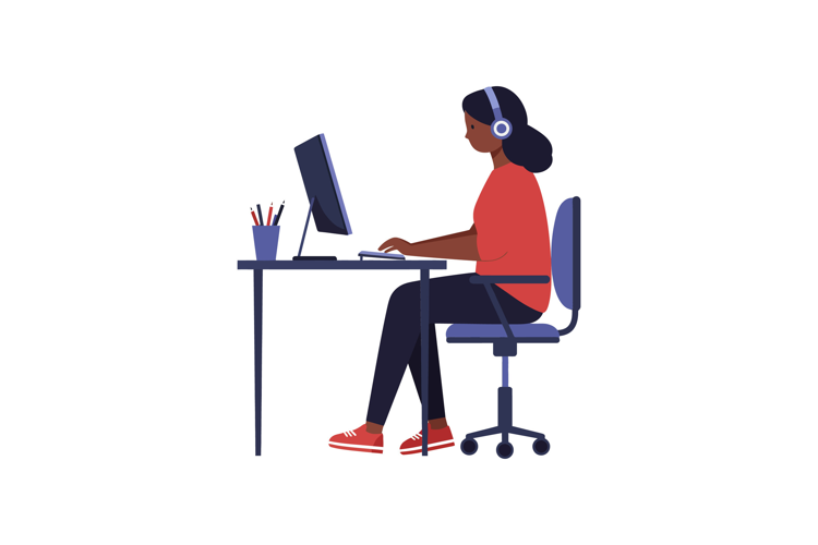Young woman working at a desk with a computer in a flat desi