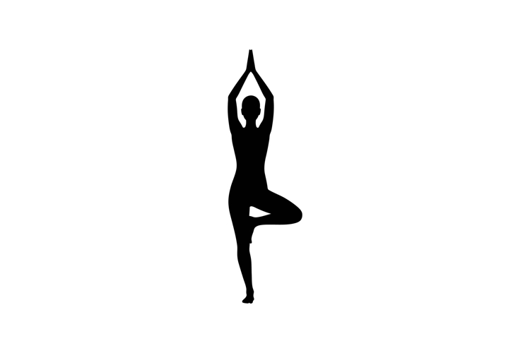 Silhouette of a woman practicing yoga in a tree pose with a