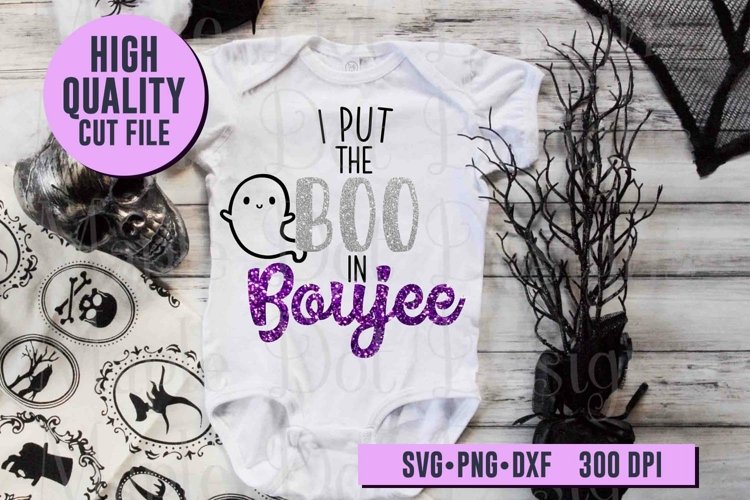 I Put the Boo in Boujee design on white baby shirt with black and white halloween decor on wood background