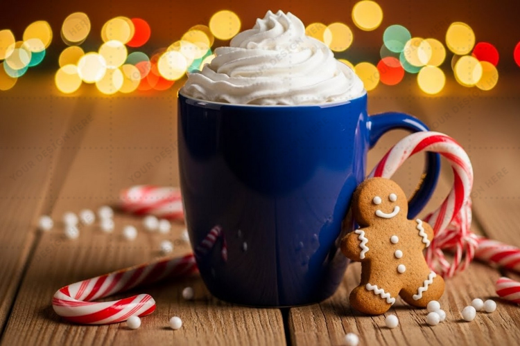 Holiday-themed blue mug with whipped cream and gingerbread d