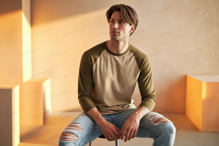 Man wearing baseball shirt and ripped jeans image