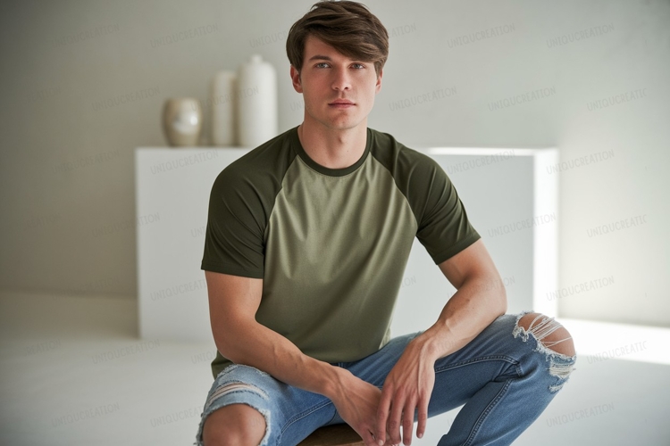 Young man wearing olive green raglan shirt ripped jeans example image 1