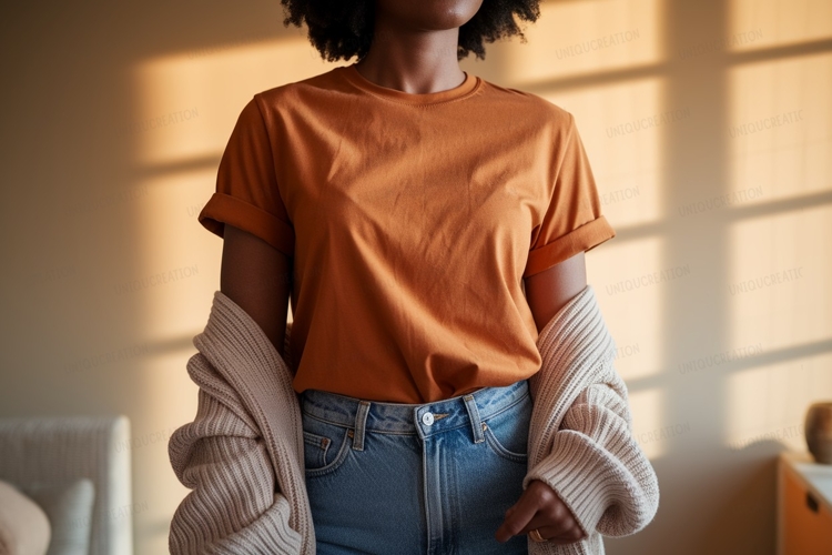 Woman wearing orange t shirt and blue jeans image