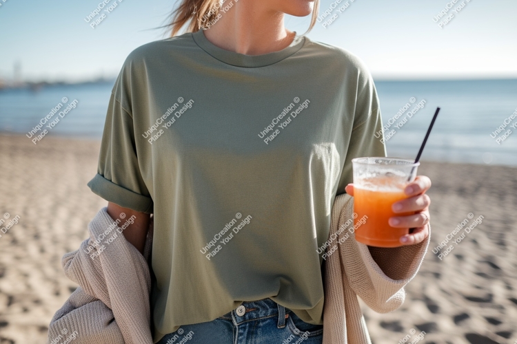 Woman holding drink on beach ocean sand
