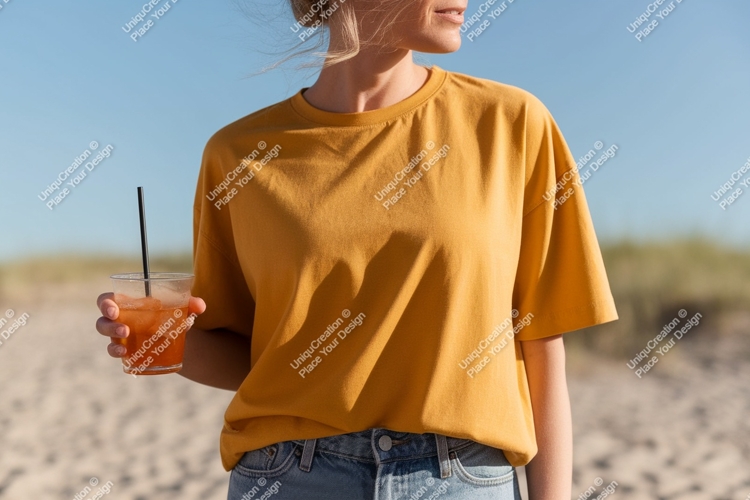 Woman wearing yellow t shirt holding drink image