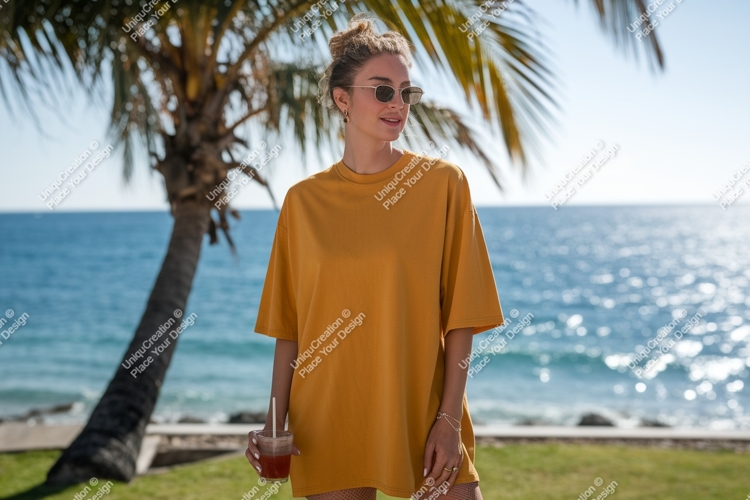 Woman wearing mustard t shirt holding drink image